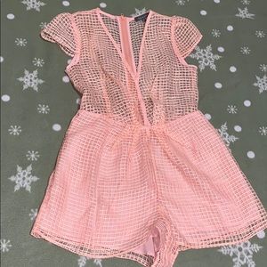 A Light pink short see through romper